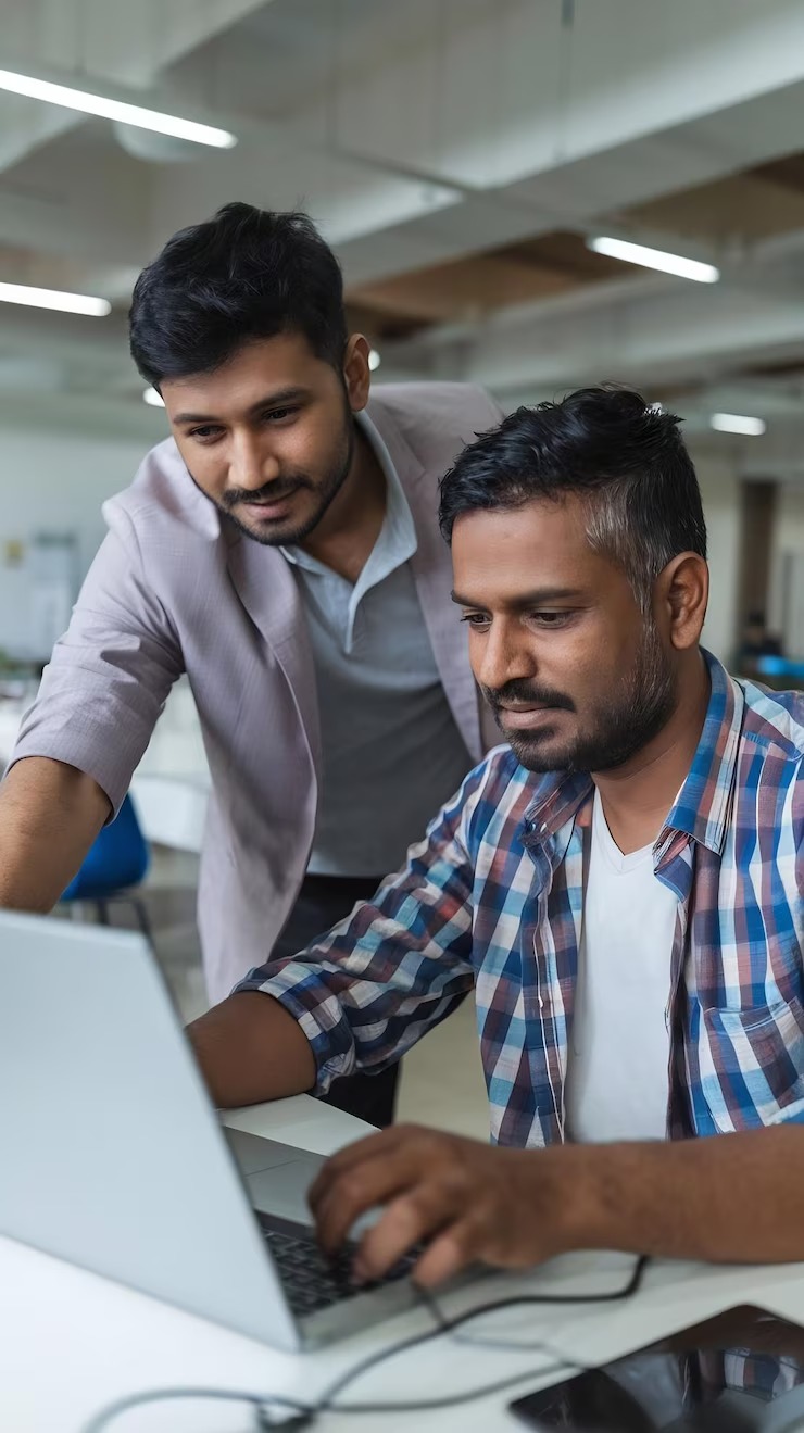 imgi_39_young-teacher-checking-up-indian-man-with-laptop-computer-helping-him-with-task-complimen_1313853-102976