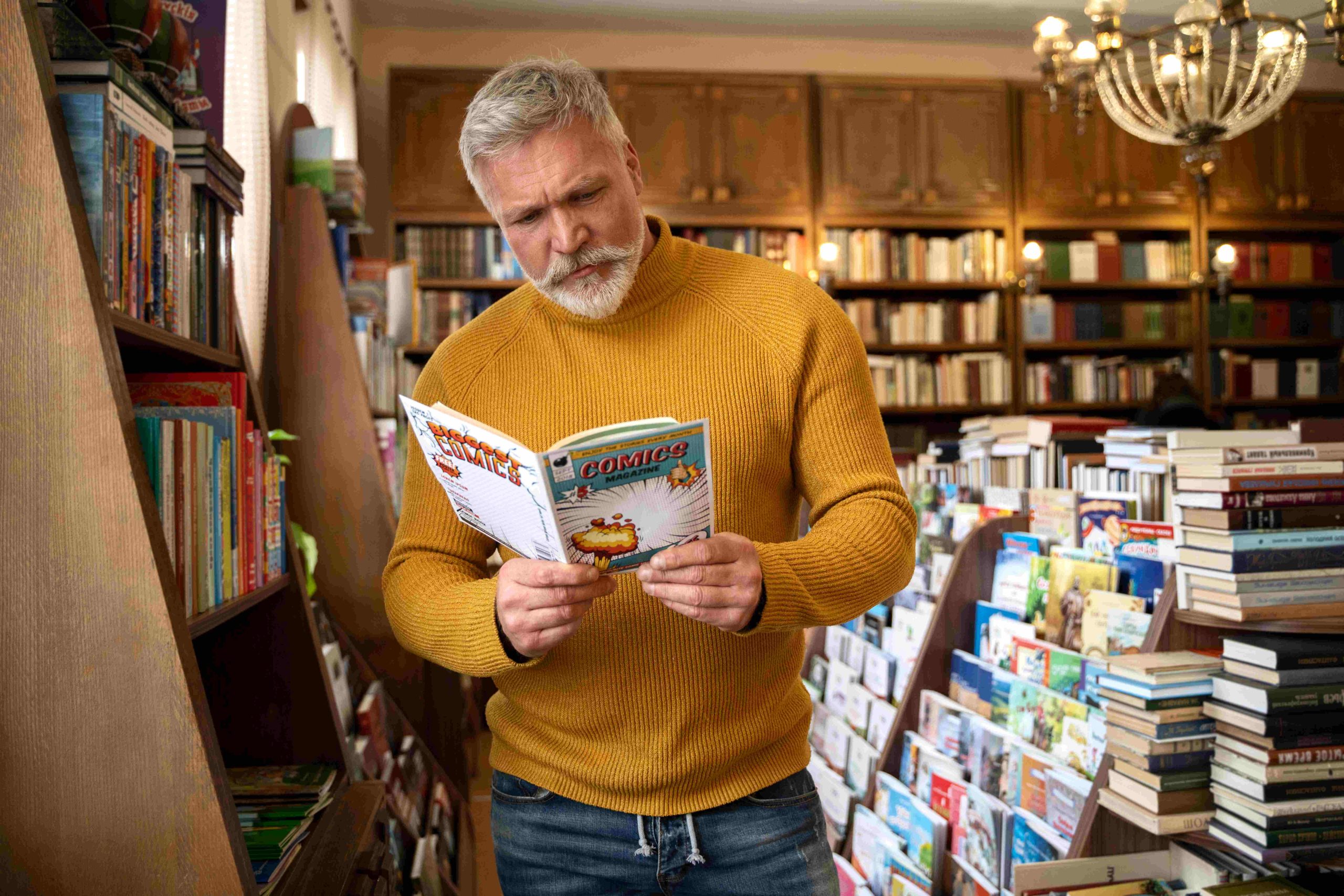 medium-shot-senior-man-reading-comics-compressed
