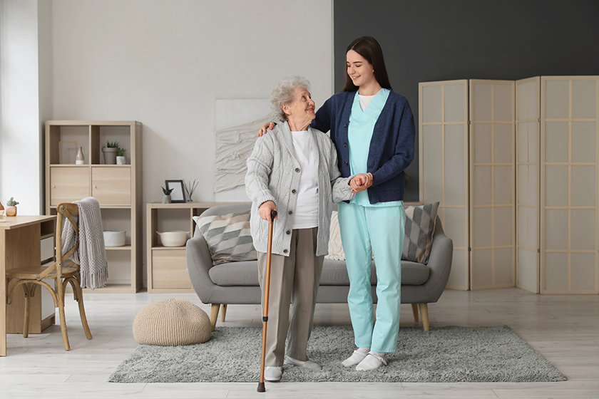 young-caregiver-helping-senior-woman