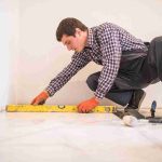 home-tile-improvement-handyman-with-level-laying-down-tile-floor_11zon