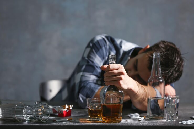 drunk-man-sitting-table-with-alcohol-drugs-alcoholism-concept_392895-104157