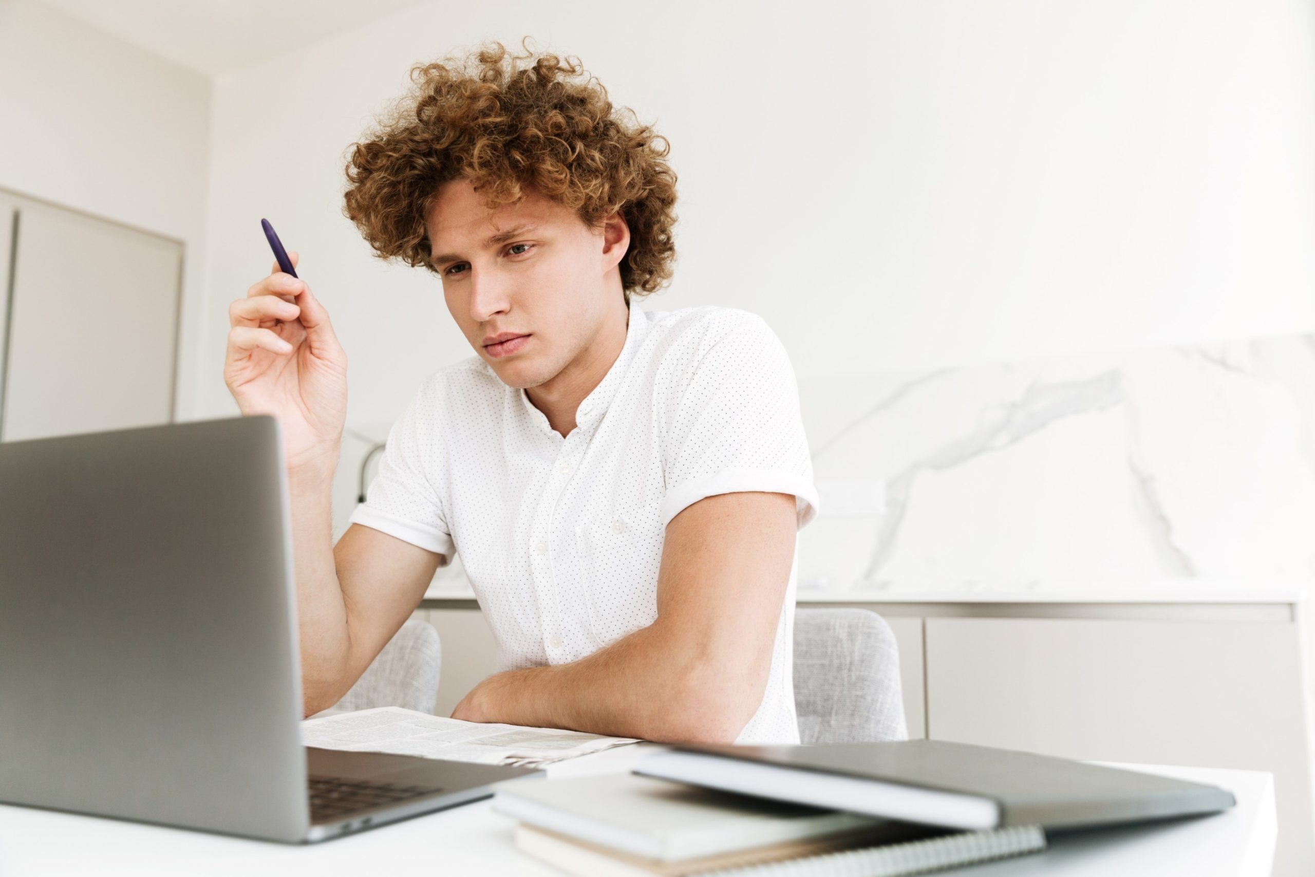 handsome-concentrated-serious-man-using-laptop-computer (1) (1)