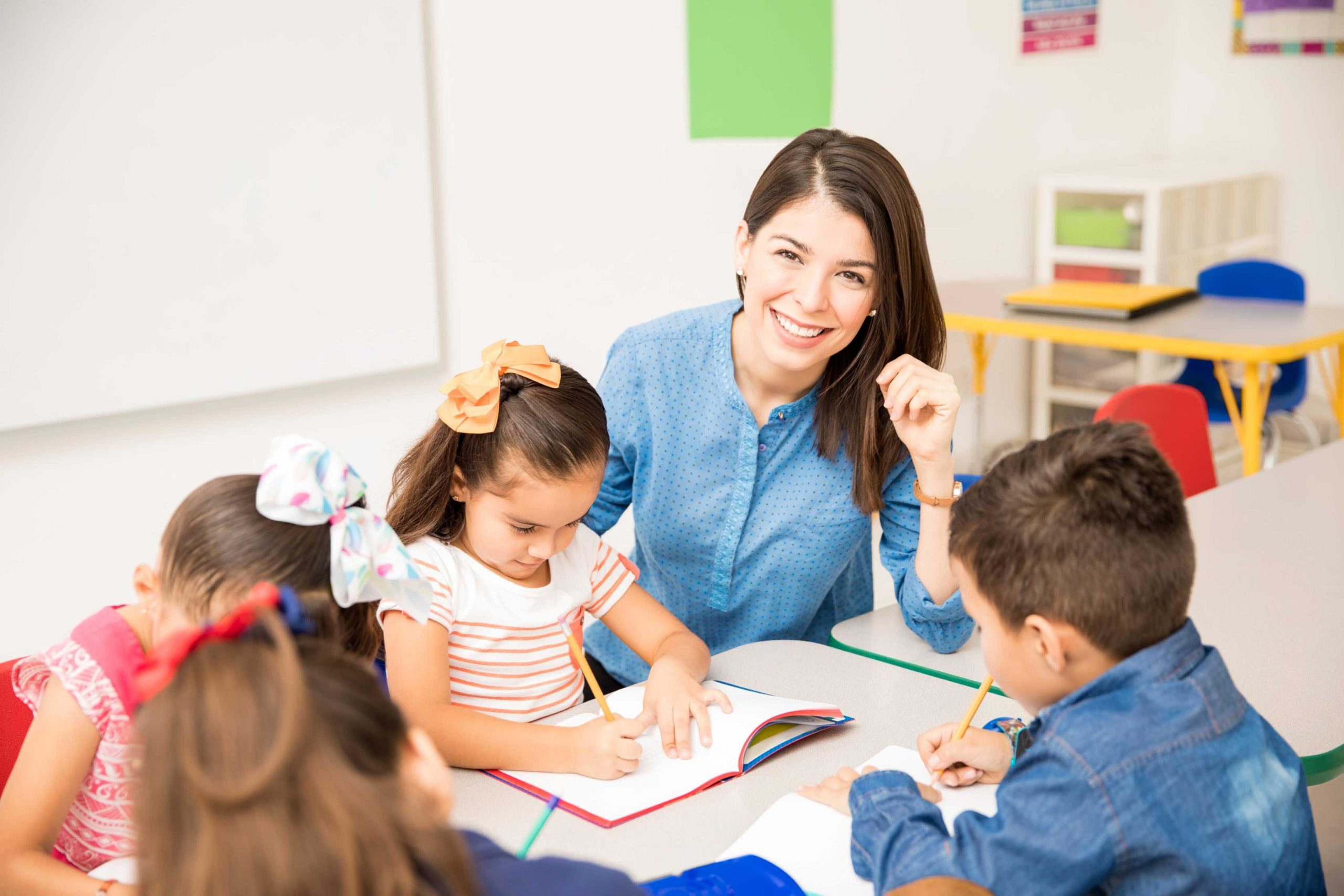 u9900-portrait-gorgeous-hispanic-preschool-teacher-teaching-her-students-classroom